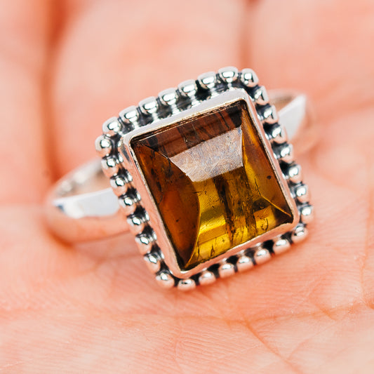 Sterling silver ring with square amber tourmaline center and raised beaded bezel