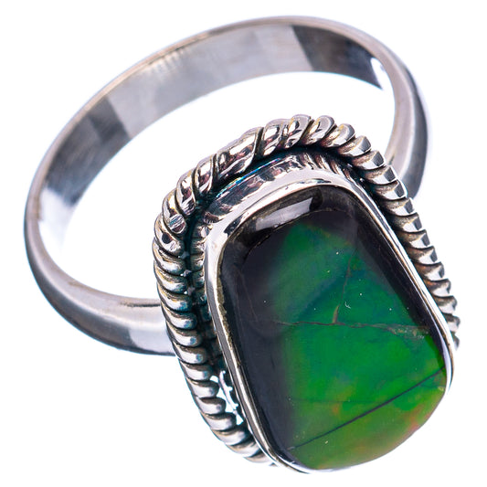 Silver ammolite ring with twisted rope band and dark green oval gemstone.