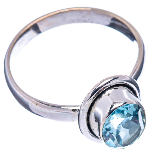 Sterling silver band ring with blue topaz bezel set in round prong-like mount