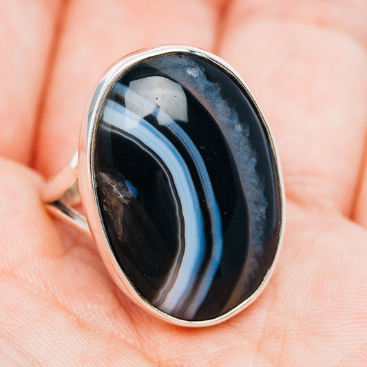 Sterling silver ring with oval dark agate cabochon and blue band stripe, bezel set