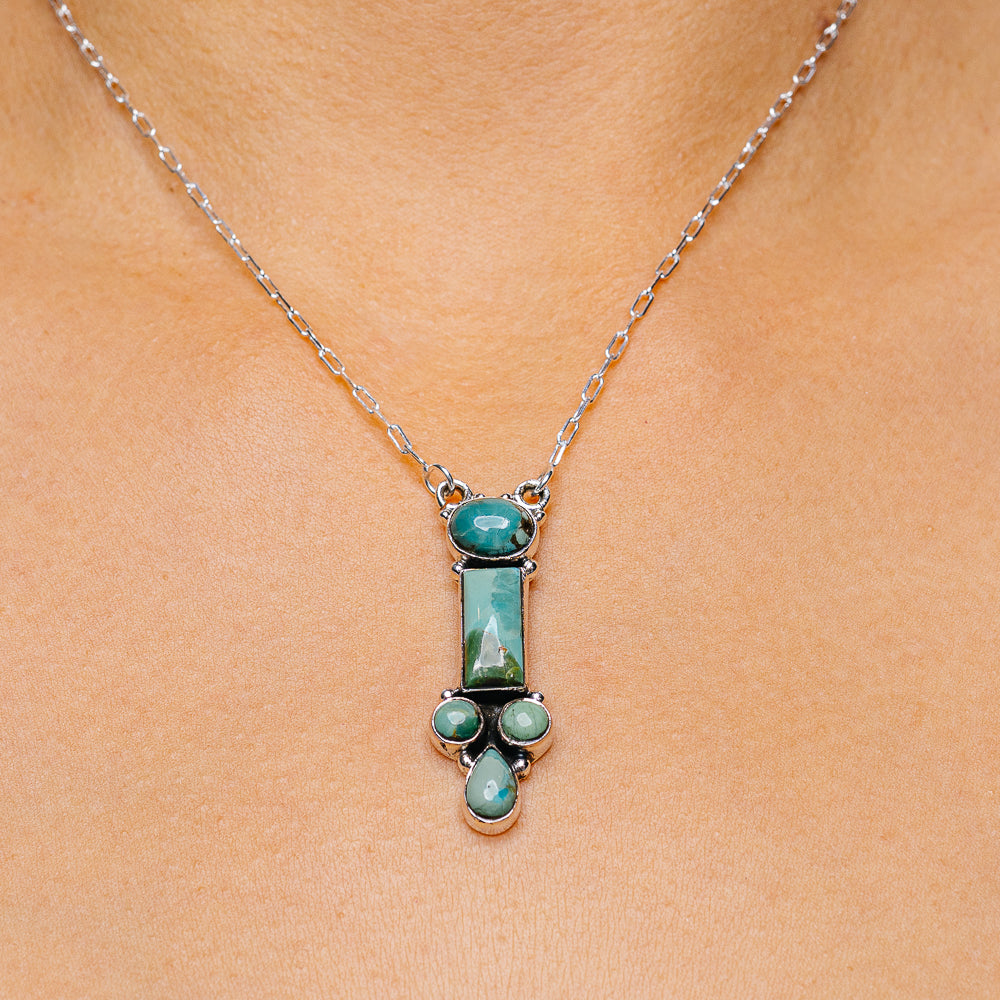 Sterling silver turquoise pendant necklace with oval stone and teardrop accents