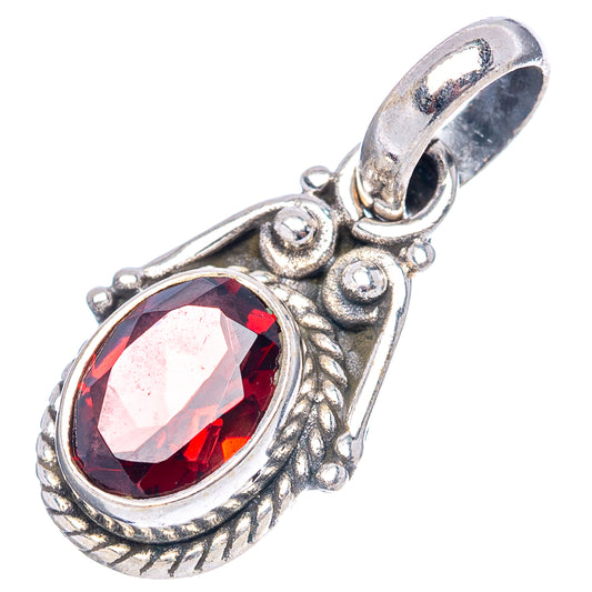 Sterling silver garnet pendant with oval red faceted stone and textured frame.