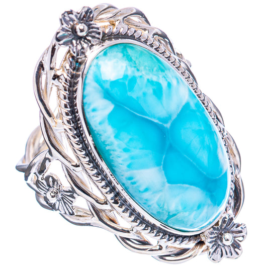 Sterling silver ring featuring a bright blue oval larimar gemstone with side scrollwork