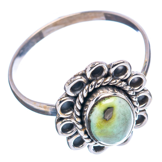 Sterling silver ring with oval green-blue cabochon, scalloped halo, and band