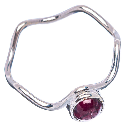 Sterling silver open band ring with round dark red garnet bezel, side angle