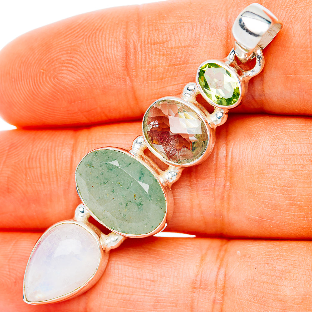 Sterling silver pendant with green oval, white teardrop, and orange round gemstones