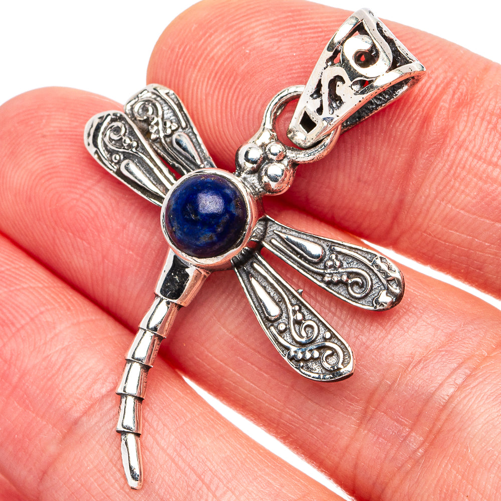 Silver dragonfly pendant with blue lapis cabochon and detailed filigree wings
