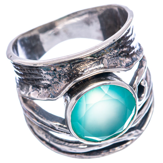 Oval teal chalcedony ring with .925 sterling silver band and swirling textured metal