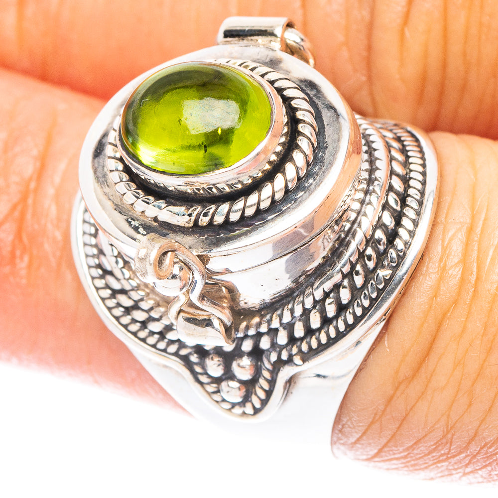 Sterling silver ring with oval green gemstone and ornate rope bezel