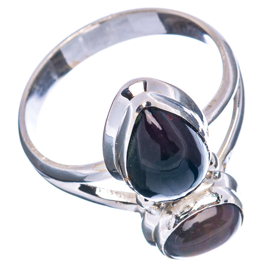 Sterling silver ring with dark oval cabochon centerpiece and second dark stone accent