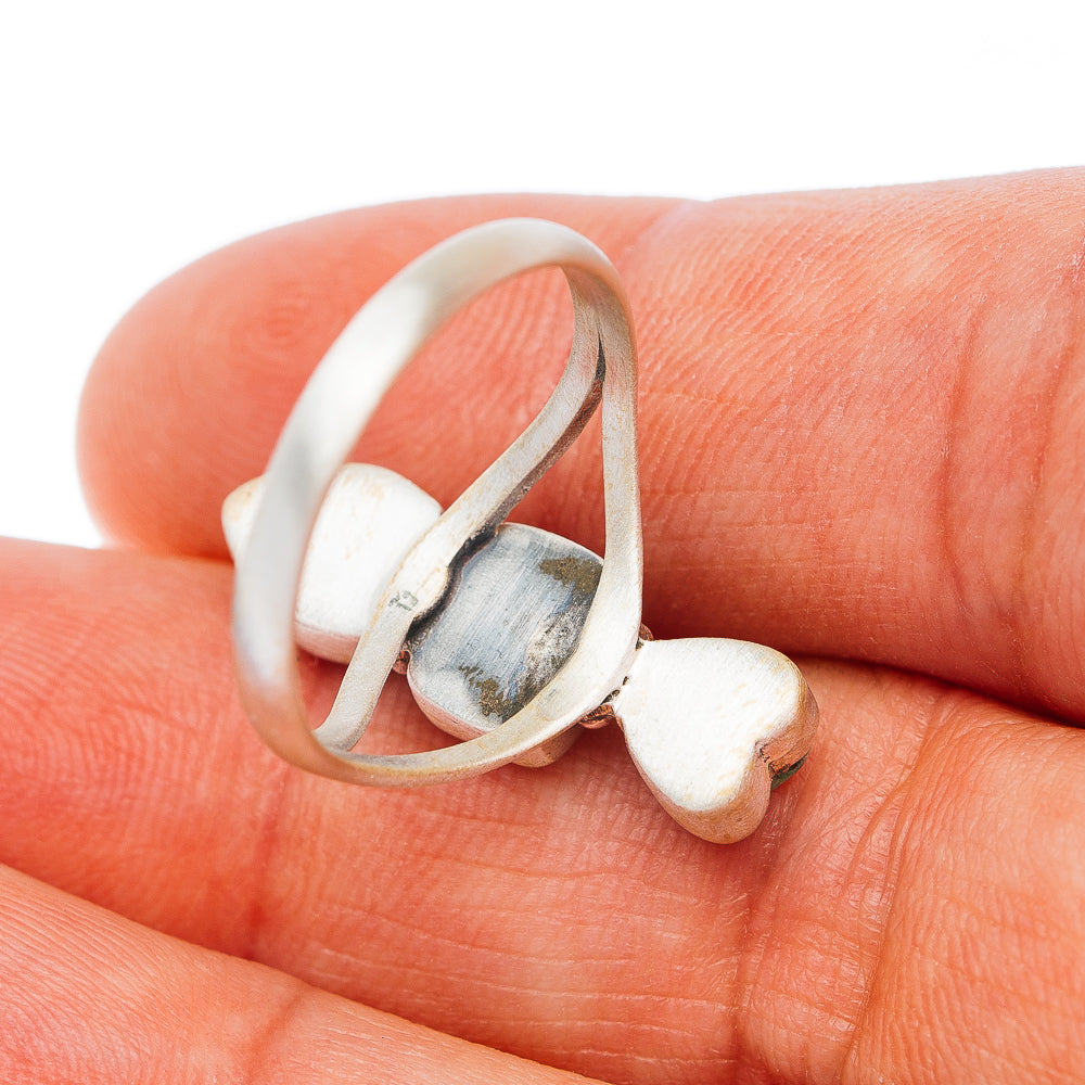 Sterling silver ring side view with white cabochon and heart-shaped setting