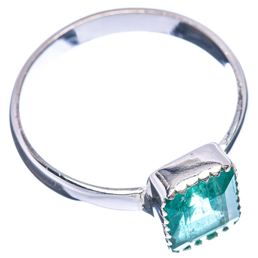 Sterling silver ring with faceted green emerald centerpiece, side view prong setting