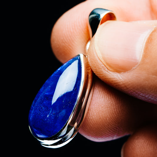 Side view of teardrop blue tanzanite pendant in .925 sterling silver, glossy setting