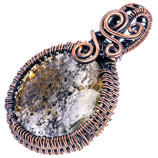 Oxidized copper wire-wrapped pendant featuring dark speckled oval stone and loop bail