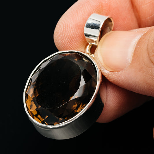 Sterling silver pendant with bezel-set faceted smoky quartz round stone and bail