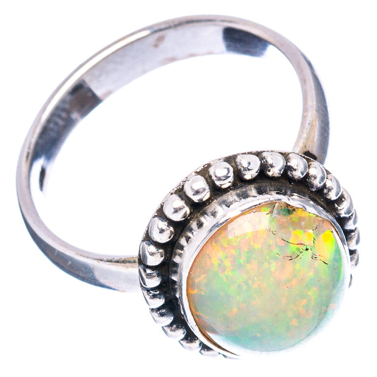 Sterling silver opal cabochon ring with beaded halo and iridescent oval stone, side view