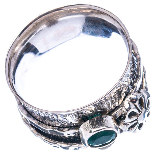 Oval green gemstone on sterling silver ring with ornate cutout and floral engraving