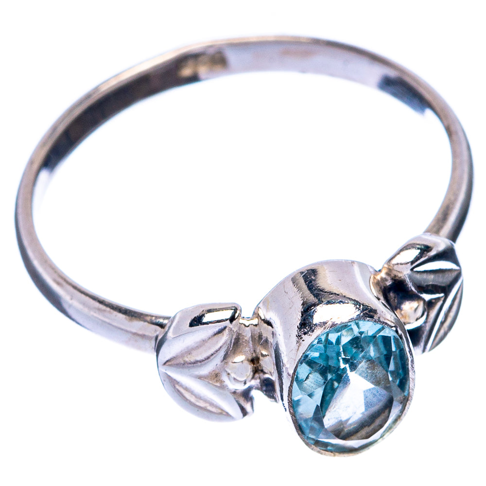 Sterling silver ring with oval blue topaz center and bow-like band details