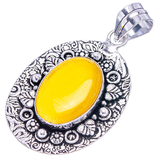 Silver filigree oval pendant with yellow cabochon and top hanging loop, side view