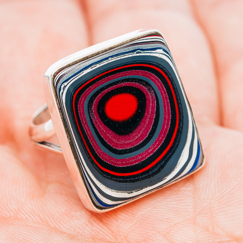 Sterling silver ring with square face, concentric blue black red bands and red center