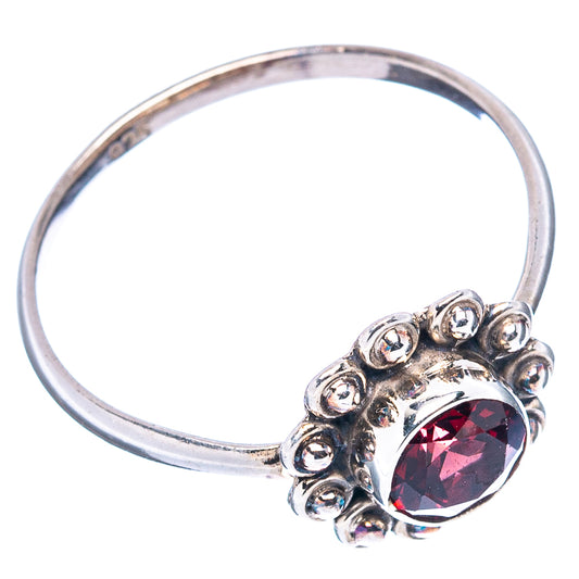 Garnet sterling silver ring with round red center stone and raised bead halo band
