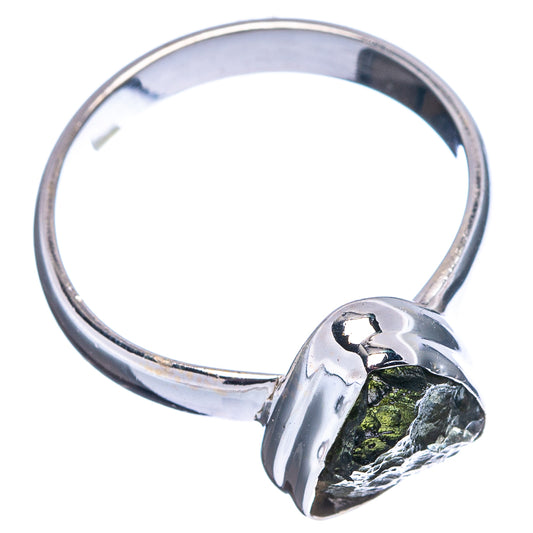 .925 sterling silver ring with polished band and bezel-set rough green moldavite stone.