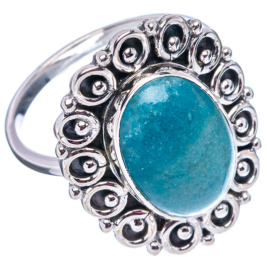 Turquoise oval cabochon sterling silver ring with ornate halo setting; visible band