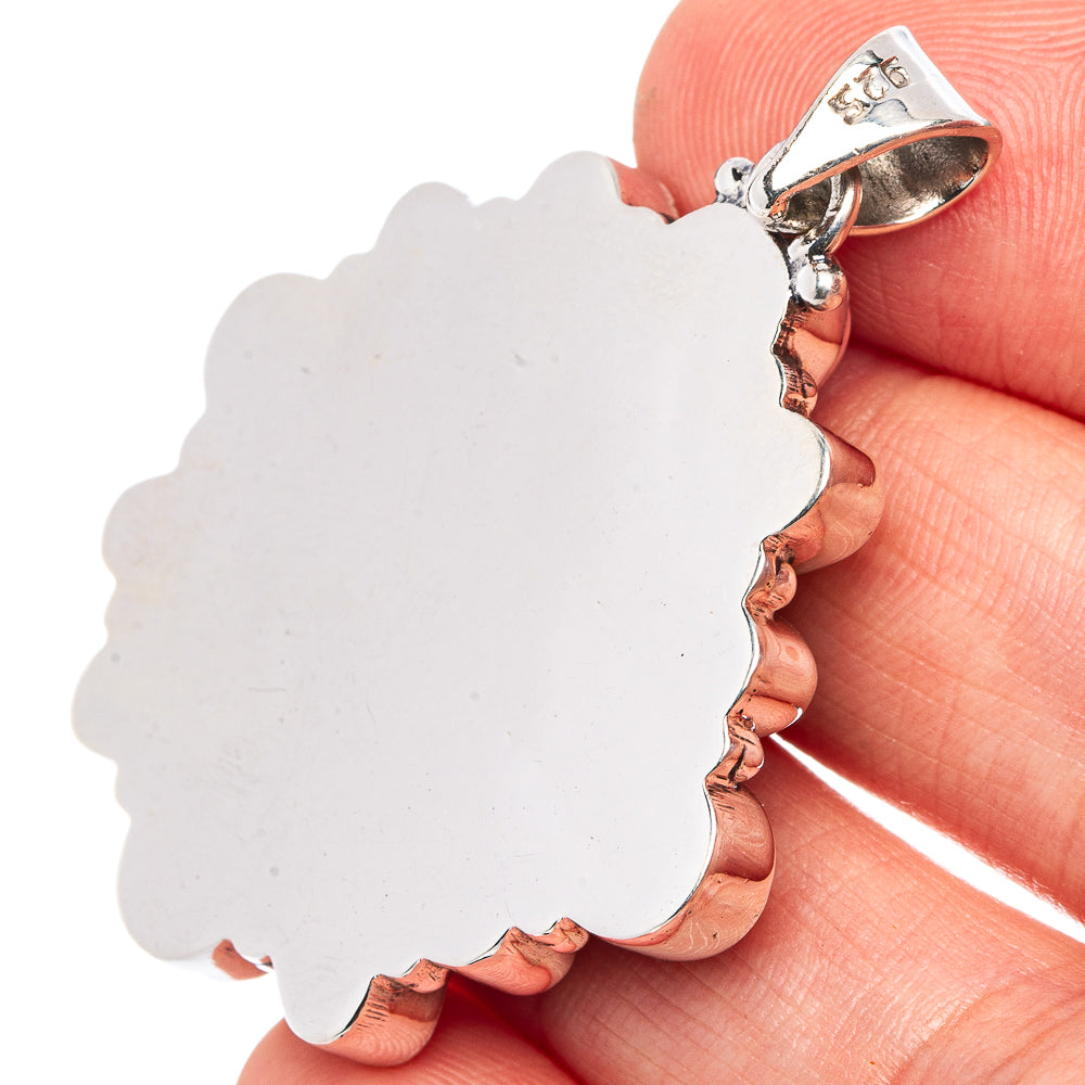 Scalloped silver back of pendant with top bail and smooth center