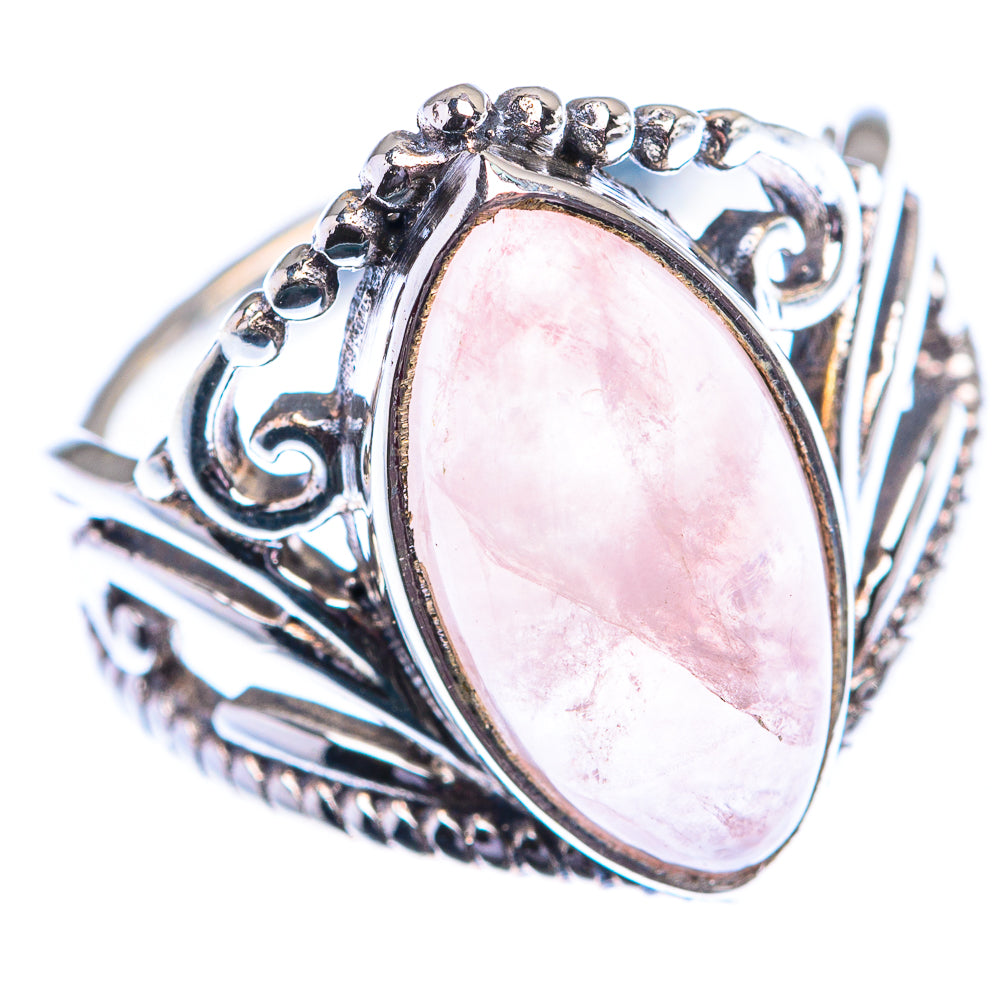 Rose quartz oval sterling silver ring with decorative scrollwork and prong settings