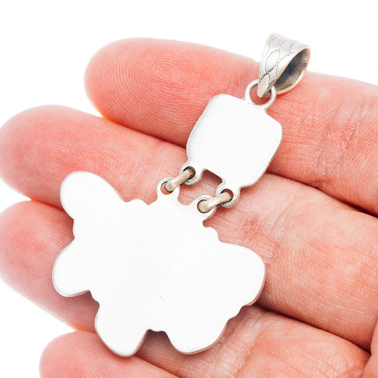 Sterling silver pendant with ornate ribbon bail and flower-like outline
