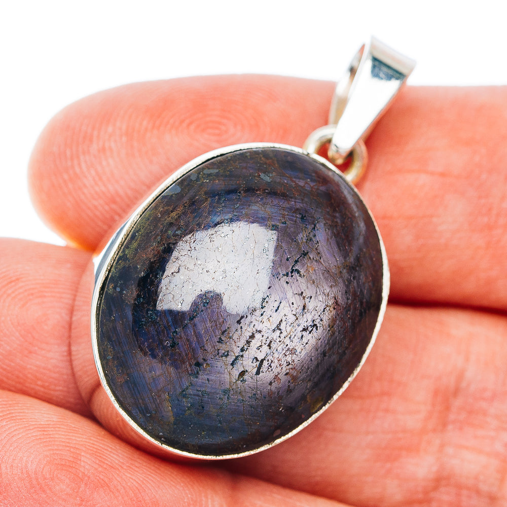 Round sterling silver pendant with dark purple-blue cabochon and bail