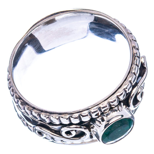 Sterling silver emerald ring with green oval stone, patterned band and open interior