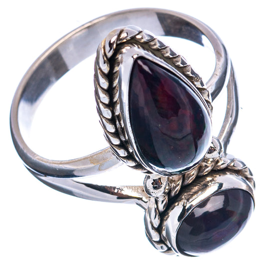 Sterling silver oval gemstone ring with ornate top setting, two dark stones and polished band
