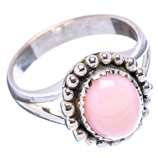 Sterling silver ring with pink oval center stone and raised beaded halo