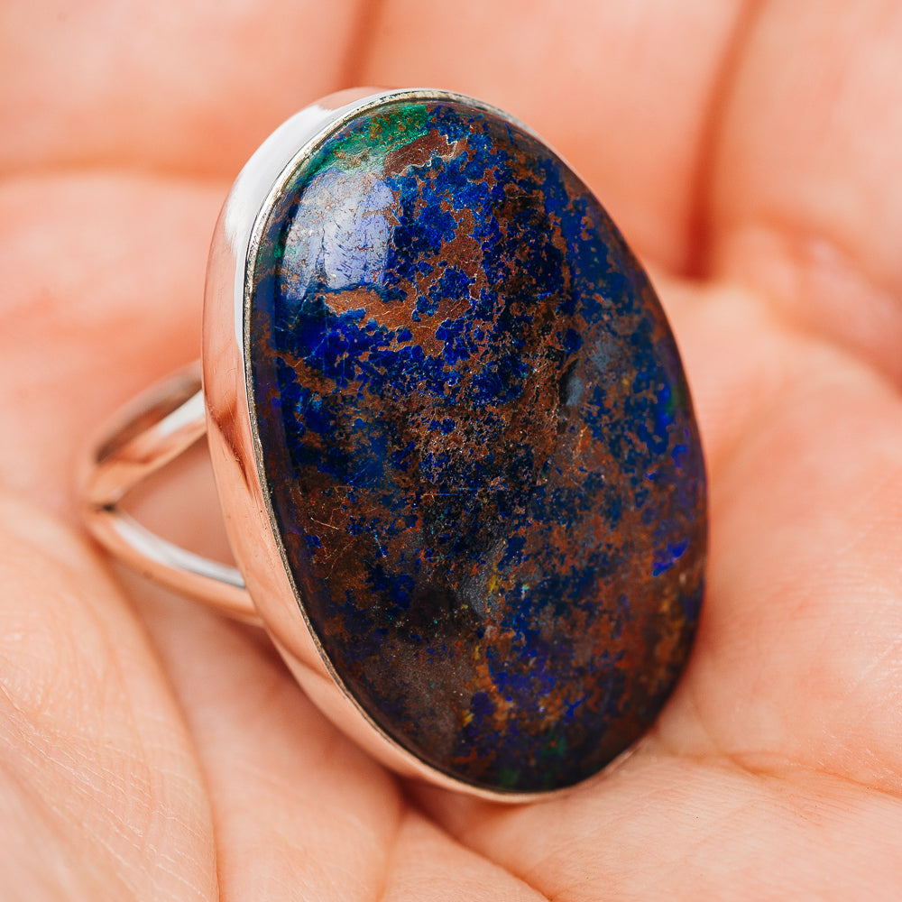Oval azurite cabochon sterling silver ring with slim band, blue speckled stone.