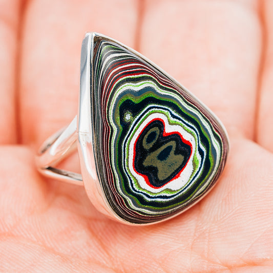Sterling silver fordite ring with teardrop cabochon, striped black and green with red accents