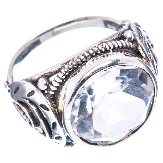 Sterling silver ring with oval clear gemstone bezel and decorative scrollwork band