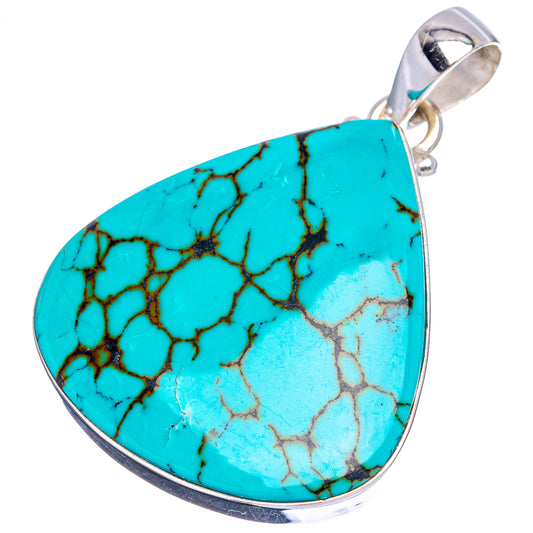 Turquoise teardrop pendant with crackle stone texture and silver bail, angled view