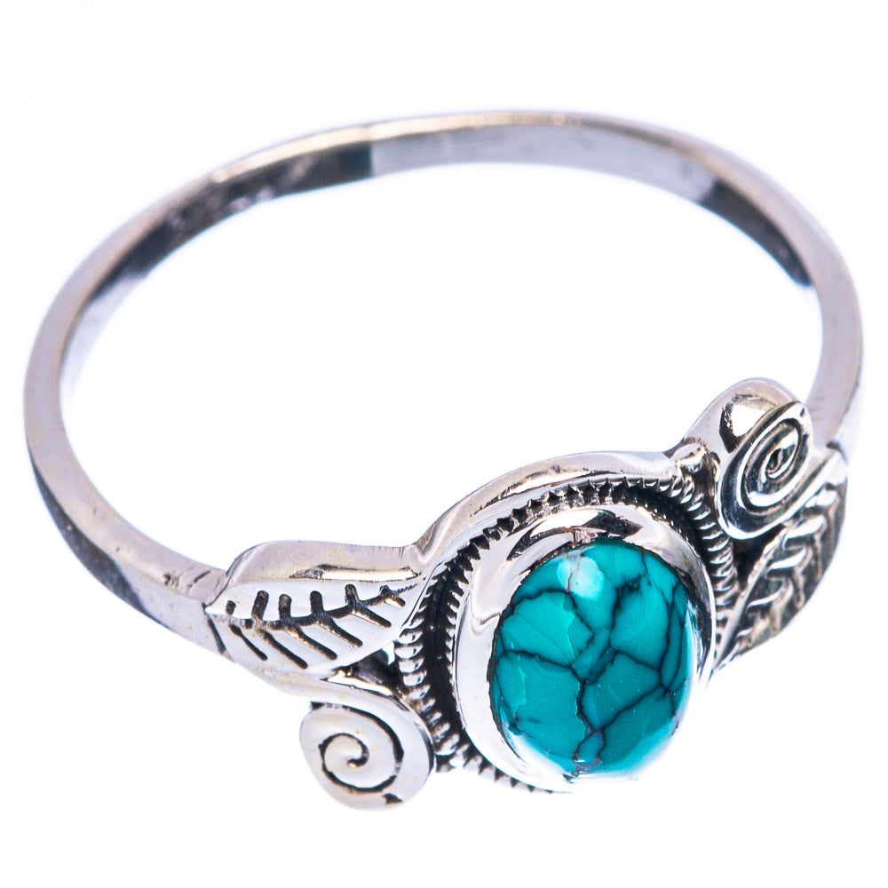 Sterling silver ring with raised turquoise cabochon and scroll side accents
