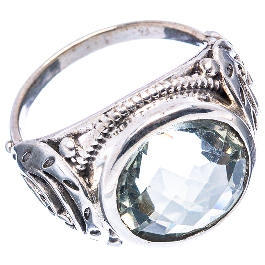 Oval green amethyst set in an antique sterling silver ring with decorative bezel and filigree.