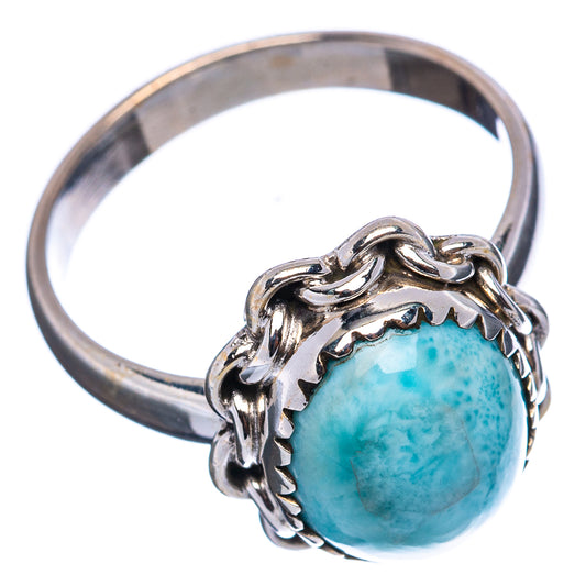 Sterling silver ring featuring blue-green larimar cabochon in twisted frame