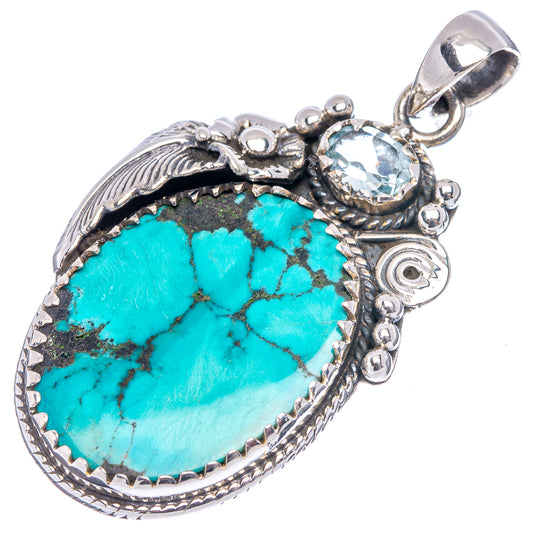 Turquoise teardrop pendant with blue stone center and ornate .925 sterling silver bail
