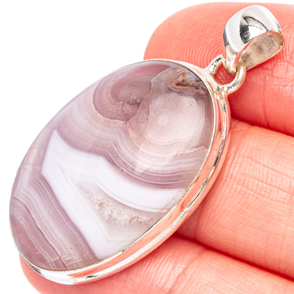 Oval Botswana agate pendant with purple, pink, and white banded stone and silver bezel