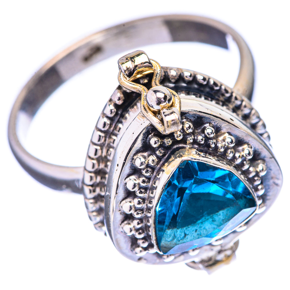 Silver ring with blue gemstone and decorative side filigree, prong setting