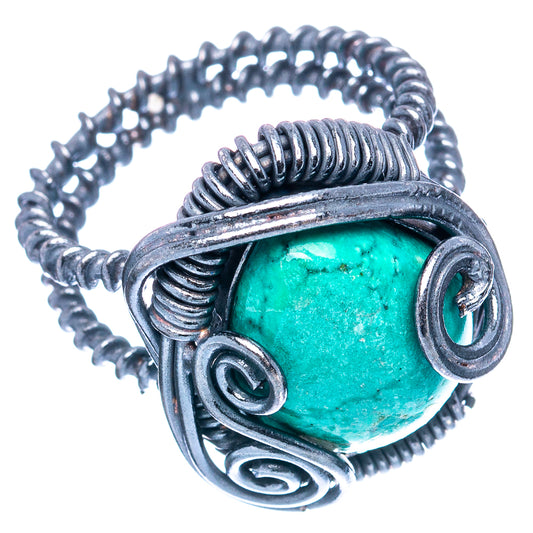 Turquoise oval cabochon sterling silver ring with spiraled wirework and side scroll details