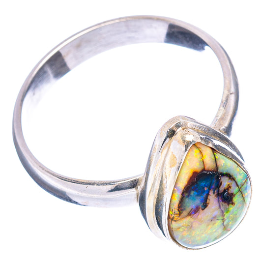 Silver band ring featuring a teardrop opal cabochon with blue and green flashes