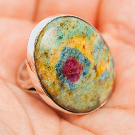 Sterling silver oval ring, side view; green-blue stone with red cabochon center