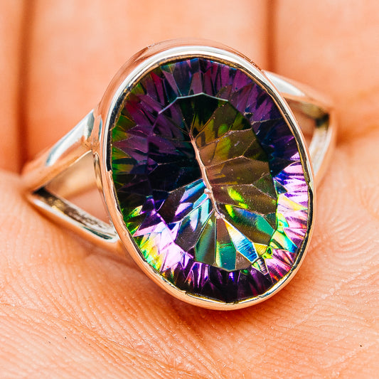 Oval faceted iridescent gemstone set in polished sterling silver ring