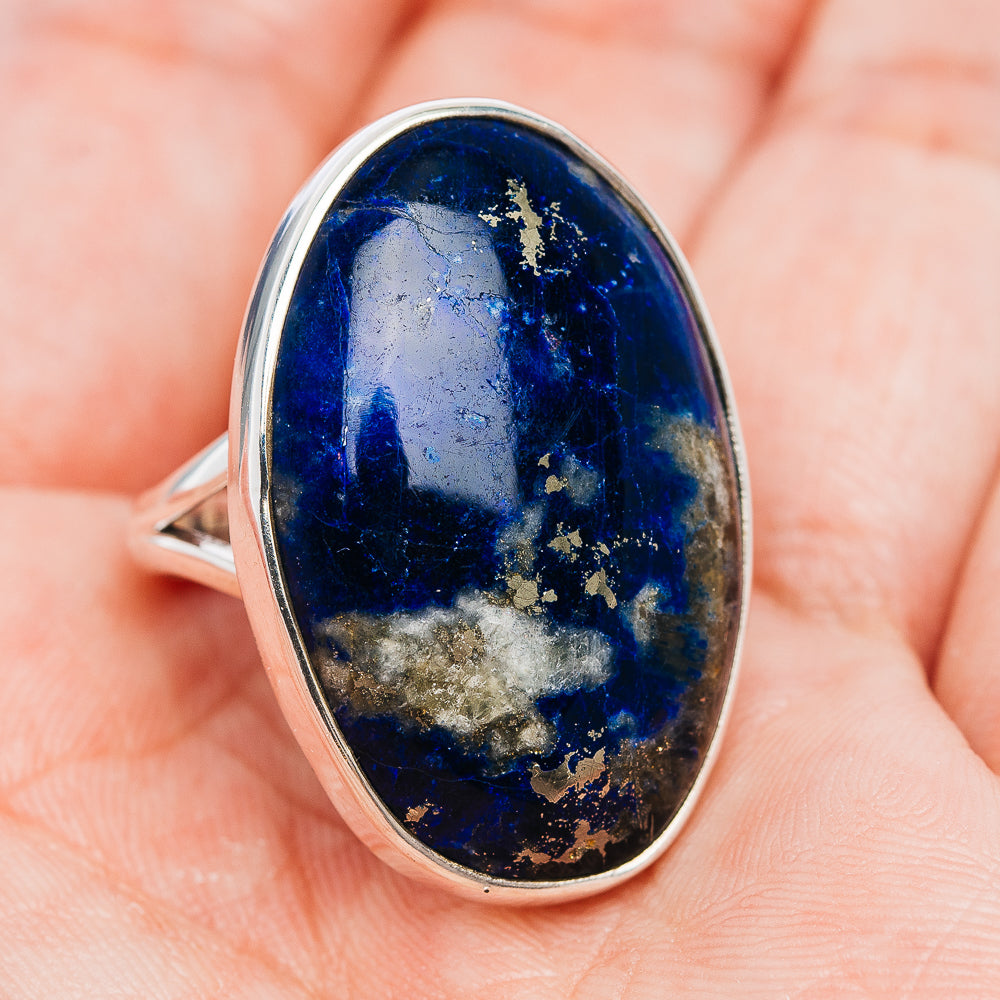 Oval afghanite ring with .925 sterling silver bezel, deep blue stone on band