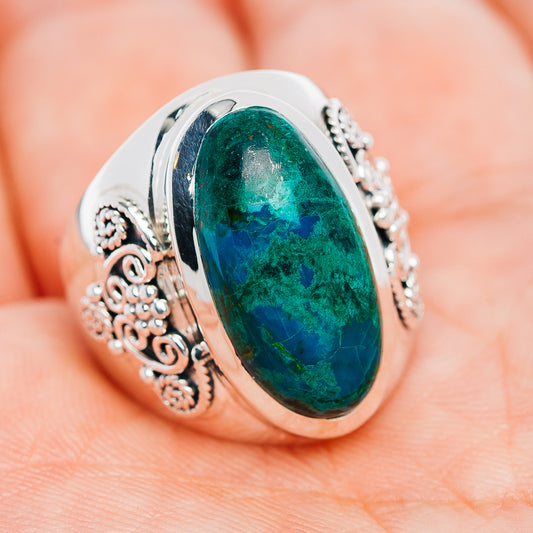 Sterling silver oval chrysocolla ring with textured bezel and detailed scrollwork